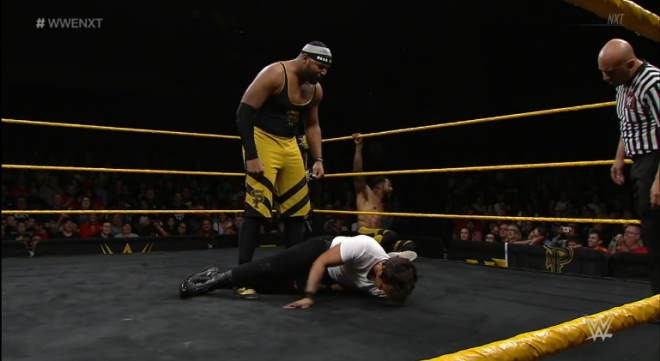 Angelo Dawkins lords over one of the Metro brothers, having knocked him on to the mat on the January 16th episode of WWE nXt.