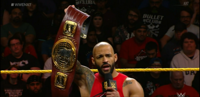 Ricochet holds up the nXt North American Championship belt, while standing in the ring during the final segment of January 23rd's nXt TV.
