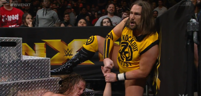 Kassius Ohno mockingly bro-fists Matt Riddle beside the steel ring steps on January 2, 2019's nXt show main event.