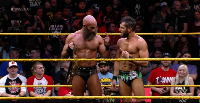 Ciampa and Gargano stand in the ring, pointing at one another, after a victory in the 2019 Dusty Rhodes Tag Team Classic tournament.